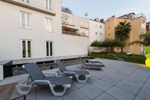 a group of chairs sitting on a patio at Apartments Pateo - Lisbon Lounge Suites in Lisbon
