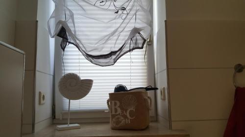 a window with a pair of shoes and an umbrella at Kleine Auszeit in Stolpe auf Usedom