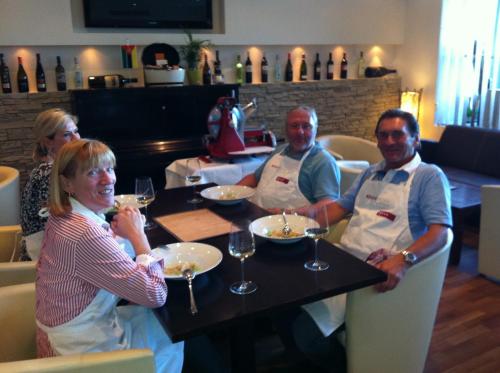 a group of people sitting at a table with wine glasses at Hotel Restaurant Pusswald in Hartberg