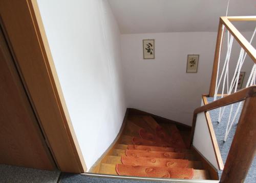 a staircase in a house with a wooden floor at Green Corner Nürburg in Nürburg