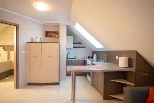 a kitchen with a counter top in a room at Apartament Luna in Giżycko