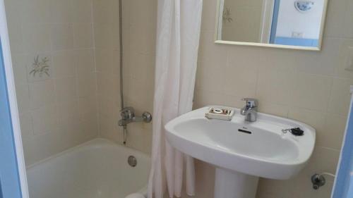 a bathroom with a sink and a bath tub and a sink at Hotel del Mar in Sant Feliu de Guixols