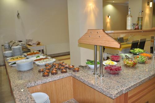 a kitchen counter with a bunch of food on it at Perla Hotel in Dikili