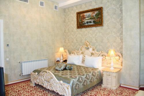 a bedroom with a large bed with a white bedspread at Spring Hotel in Novxanı