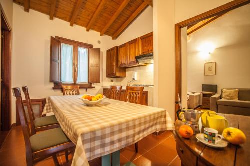 a kitchen with a table with a bowl of fruit on it at Il Poggio degli Olivi in Bettona