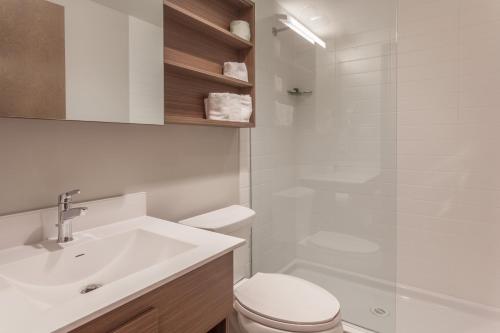 a bathroom with a sink and a toilet and a shower at Microtel Inn & Suites by Wyndham Val-d Or in Val-dʼOr