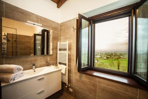 a bathroom with a sink and a window at Il Poggio degli Olivi in Bettona