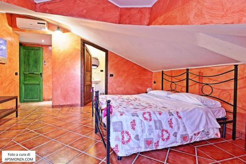 a bedroom with a bed and a green door at Casale Del Vento in Aprilia