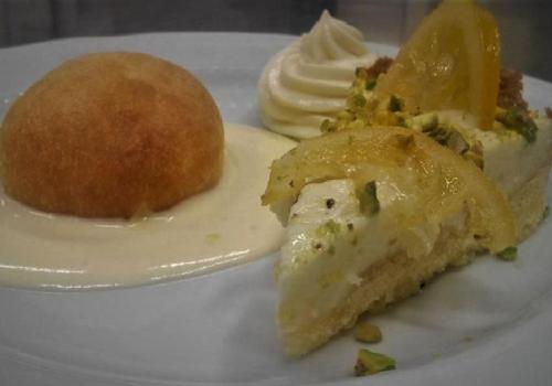 a plate of food with a piece of pie and a roll at Sant'Andrea Agriturismo con cantina Martignago Vignaioli Asolo Prosecco Docg Wines in Maser