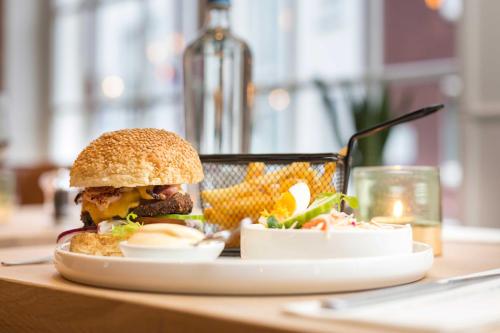 a plate with a sandwich and corn on a table at Hotel - Restaurant De 4 Jaargetijden in Epen
