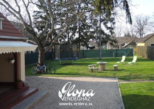 a park with a bike parked next to a tree at Ilona vendégház Dinnyés in Dinnyés