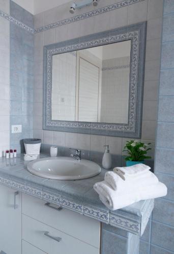 a bathroom with a sink and a mirror at Terrazza Sui Colli in Monopoli