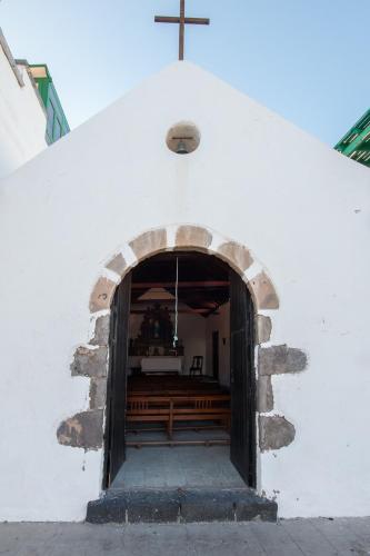 an entrance to a church with a cross at Casa Maralba Famara in Famara