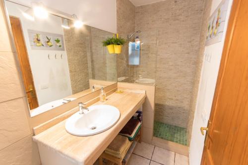 a bathroom with a sink and a mirror at Casa Maralba Famara in Famara