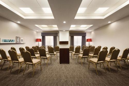 a conference room with chairs and a podium in it at Country Inn & Suites by Radisson, St Petersburg - Clearwater, FL in Pinellas Park