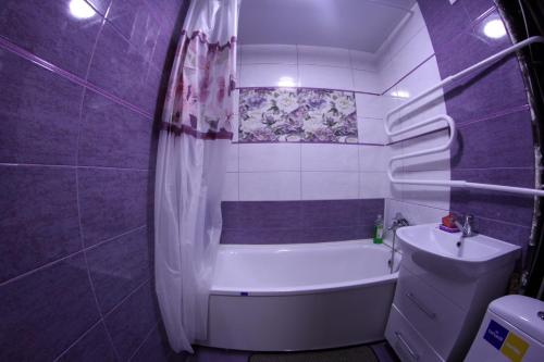 a purple bathroom with a tub and a sink at Карла Маркса in Kropyvnytskyi