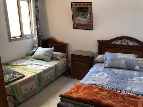 A bed or beds in a room at Emarat Hightes north coast egypt