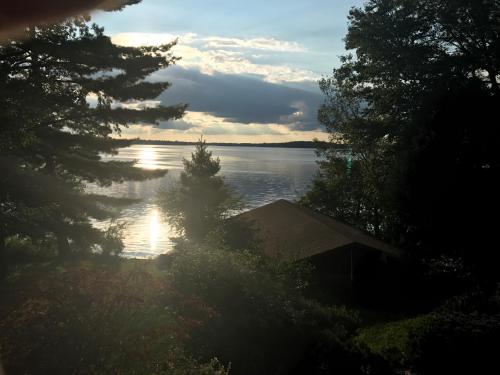 a view of a lake with a house and trees at Centerstone Resort Lake-Aire in Tomahawk