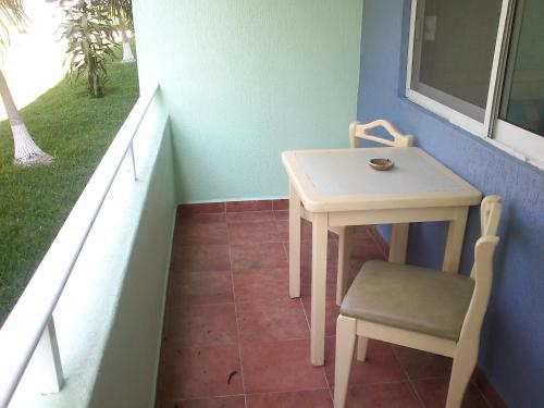 a small table and chair next to a window at Dorados Conventions & Resort in Oaxtepec