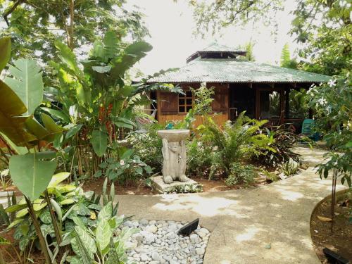 a garden with a statue in front of a building at Las Brisas del Sur in Ojochal