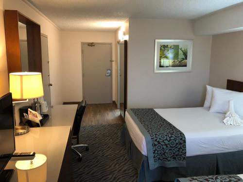 a hotel room with a bed and a desk at Days Inn by Wyndham Manassas Battlefield in Manassas