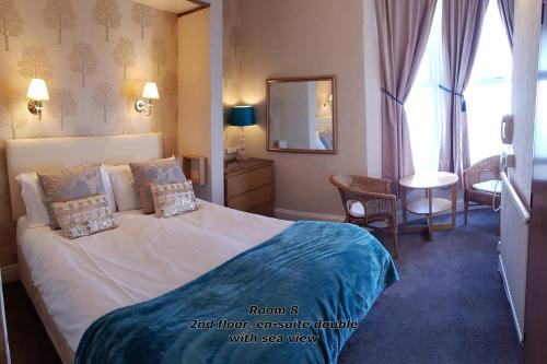 スカーバラにあるThe Paragon - Guest Accommodationのベッドと鏡が備わるホテルルーム