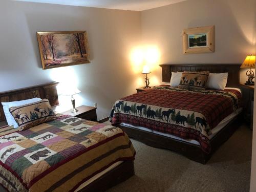 a hotel room with two beds and two lamps at Tug Hill Resort in Redfield