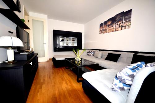 a living room with a couch and a table at Clean&Cozy Apartments Novi Beograd in Belgrade