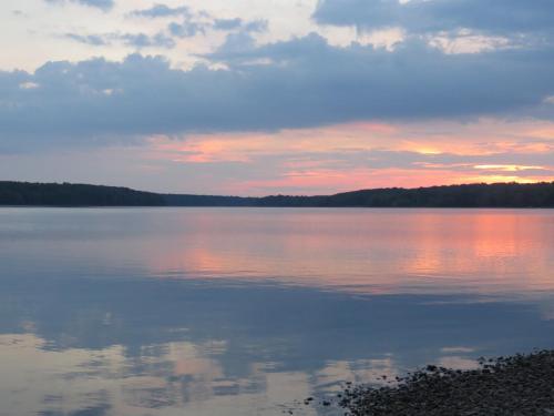 a view of a large lake at sunset at Tug Hill Resort in Redfield