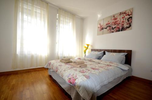 a bedroom with a large bed and a window at Clean&Cozy Apartments Novi Beograd in Belgrade