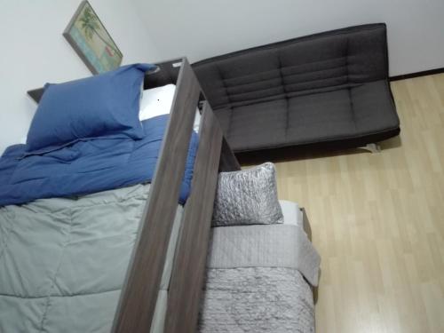 a bedroom with a bunk bed and a couch at MV Suites Suc. Capilla in Monterrey