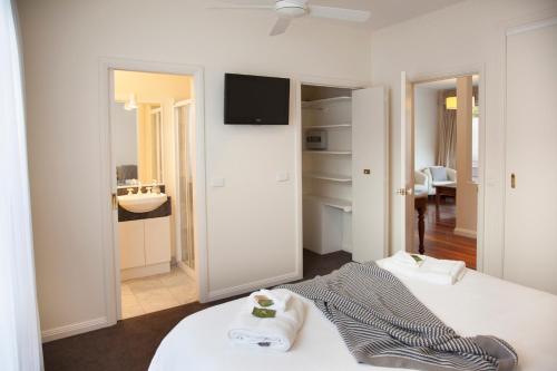 a hotel room with two beds and a bathroom at Brighton House in Melbourne