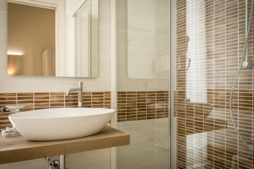 a bathroom with a white sink and a shower at Hotel Bel Soggiorno in Genova