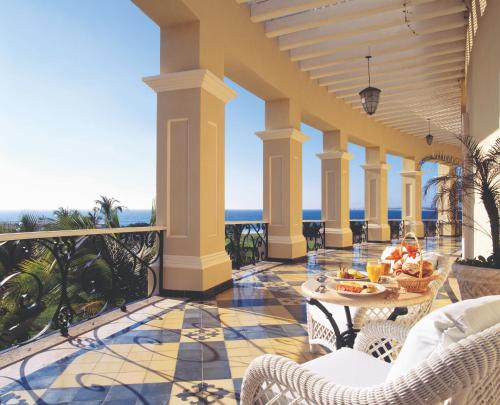 a patio with a table and chairs on a balcony at Pueblo Bonito Emerald Bay Resort & Spa - All Inclusive in Mazatlán