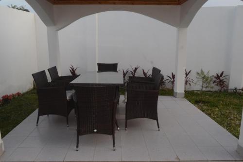 a patio with a table and chairs on it at Drammeh's Villa in Serekunda