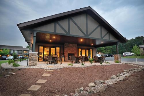 a house with a patio with tables and chairs at Sunset Bay Resort in Wisconsin Dells
