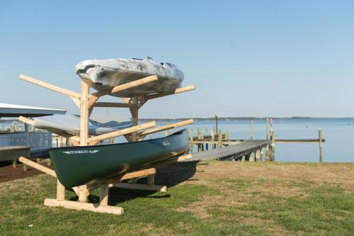 a boat on a stand next to a dock at Wylder Hotel - Tilghman Island in Saint Michaels