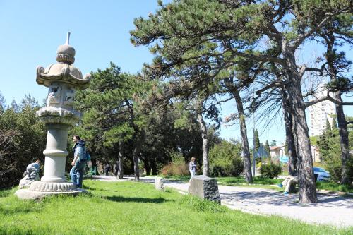 a man standing next to a monument in a park at Volcano Rijeka in Rijeka
