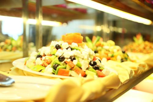 a plate of salad with vegetables on a table at Kabul Star Hotel & Restaurant in Shīrpūr