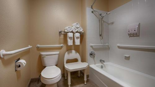 a bathroom with a toilet and a bath tub at SureStay Hotel by Best Western Zapata in Zapata