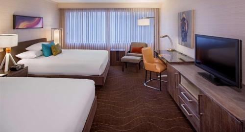 a hotel room with two beds and a television at Grand Hyatt Denver in Denver