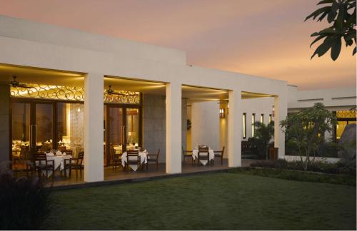 a villa with tables and chairs on a patio at Hyatt Hyderabad Gachibowli in Hyderabad