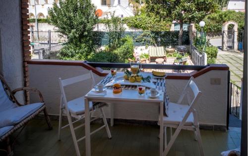 Casa vacanze Maradei في سكاليا: طاولة وكرسيين على شرفة مع طاولة