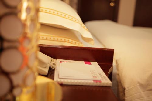 a wooden table with a box on top of a bed at Kabul Star Hotel & Restaurant in Shīrpūr