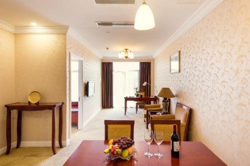 a hotel room with a table with wine glasses on it at Blue Palace Hotel in Jiading