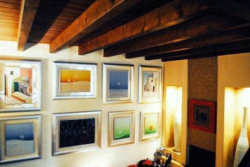 a wall with framed pictures on a wall at BeMyGuest Rutigliano in Rutigliano