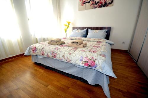 a bedroom with a bed with two towels on it at Clean&Cozy Apartments Novi Beograd in Belgrade