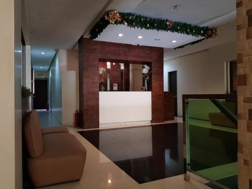 a lobby with a table and a couch and christmas lights at Hotel Giorgio in General Santos