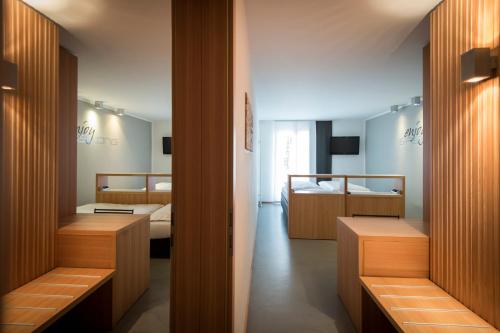 a hotel room with two beds and a television at Smart Hotel Saslong in Santa Cristina Gherdëina