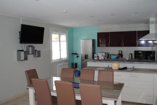 une cuisine avec une table et des chaises ainsi qu'une salle à manger dans l'établissement gîte la belle vue, à Saint-Martin-en-Campagne